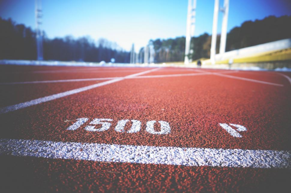 Free Image of Close-up view of red running track lanes 