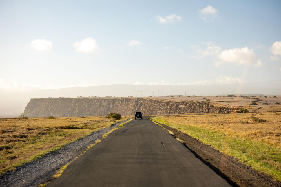 Free Image of Scenic route with car on rural road 