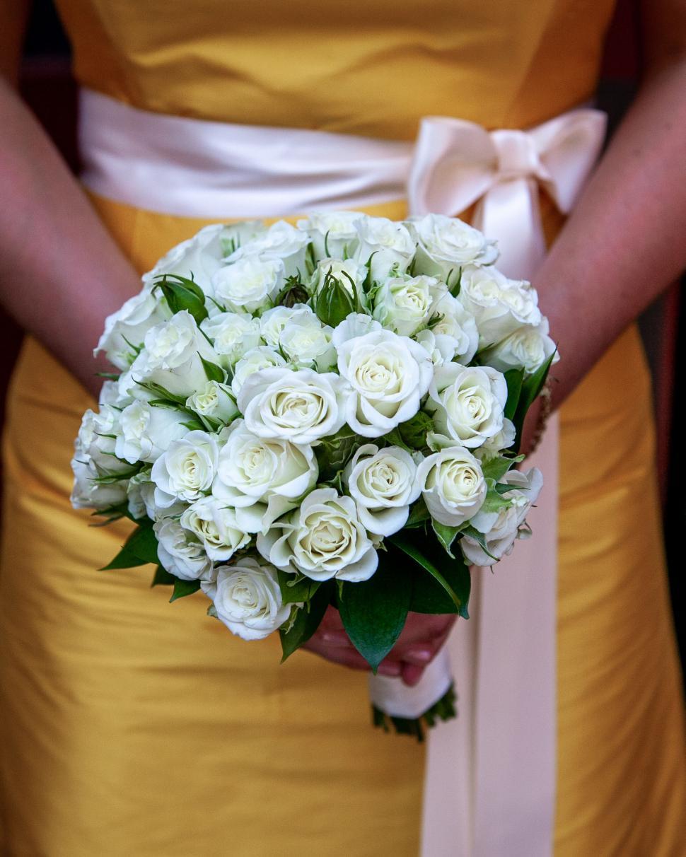 Free Image of Bridesmaid holding a bouquet of white roses 
