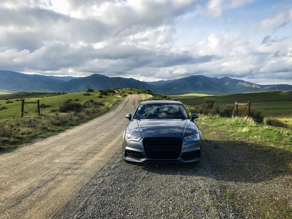 Free Image of Audi car parked on a scenic country road 