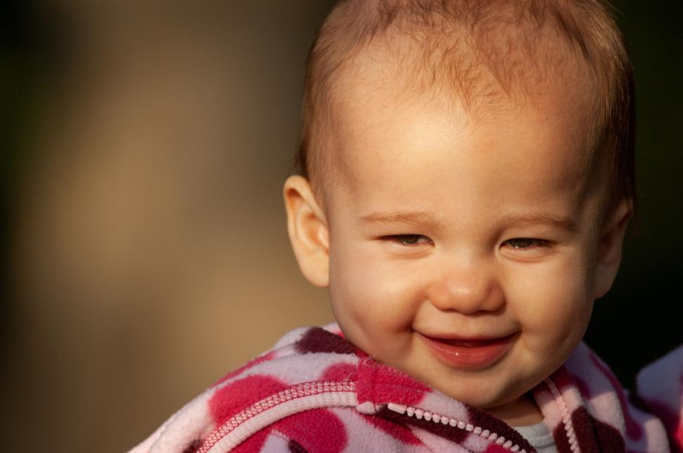 Free Image of Smiling baby with sunlight on face 