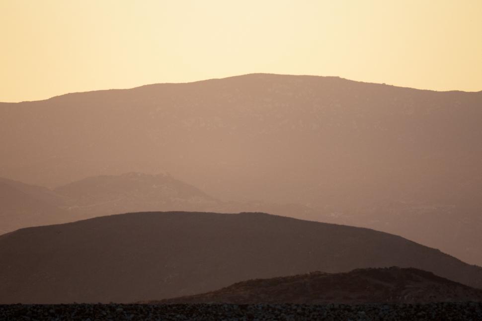 Free Image of Layers of mountain silhouettes during sunset 