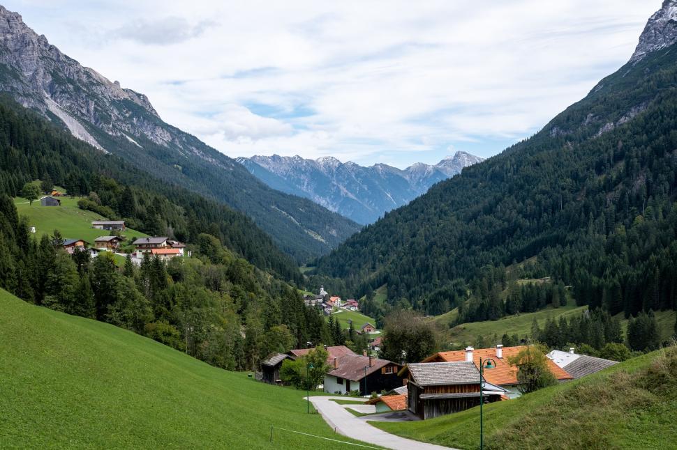 Free Image of Mountain village with green hills and blue sky 