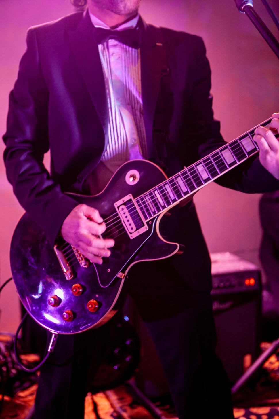 Free Image of Musician Performing with a Black Electric Guitar 