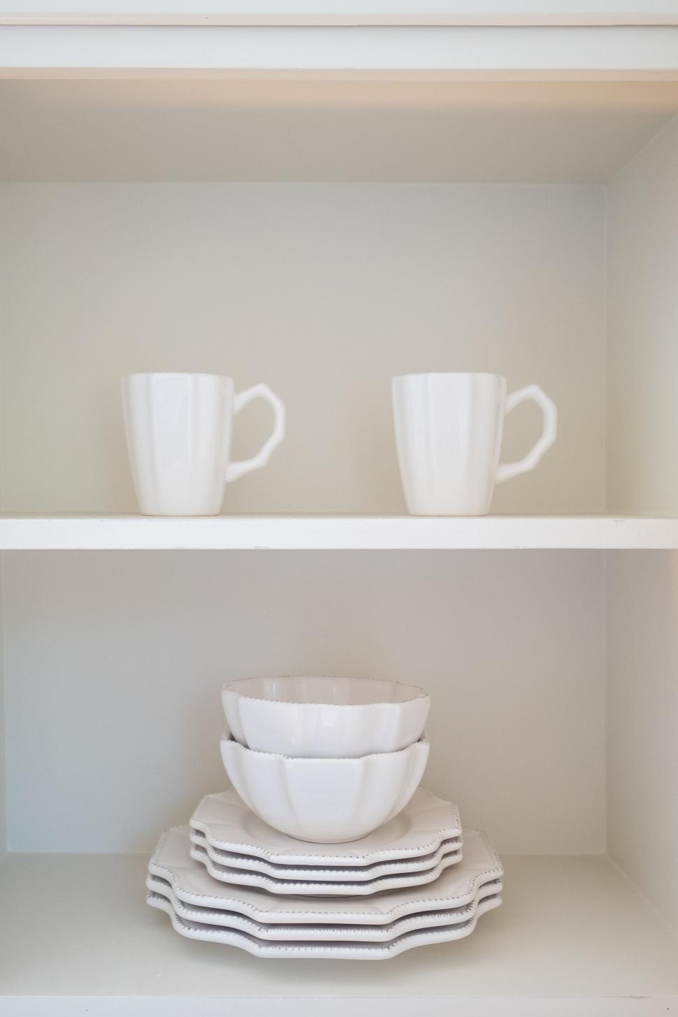 Free Image of Minimalistic white dishes on open shelves 
