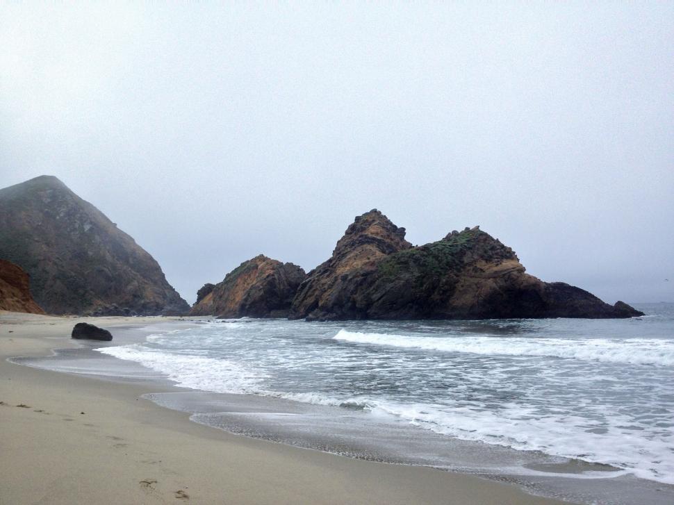 Free Image of Foggy beach with rocky mountains 