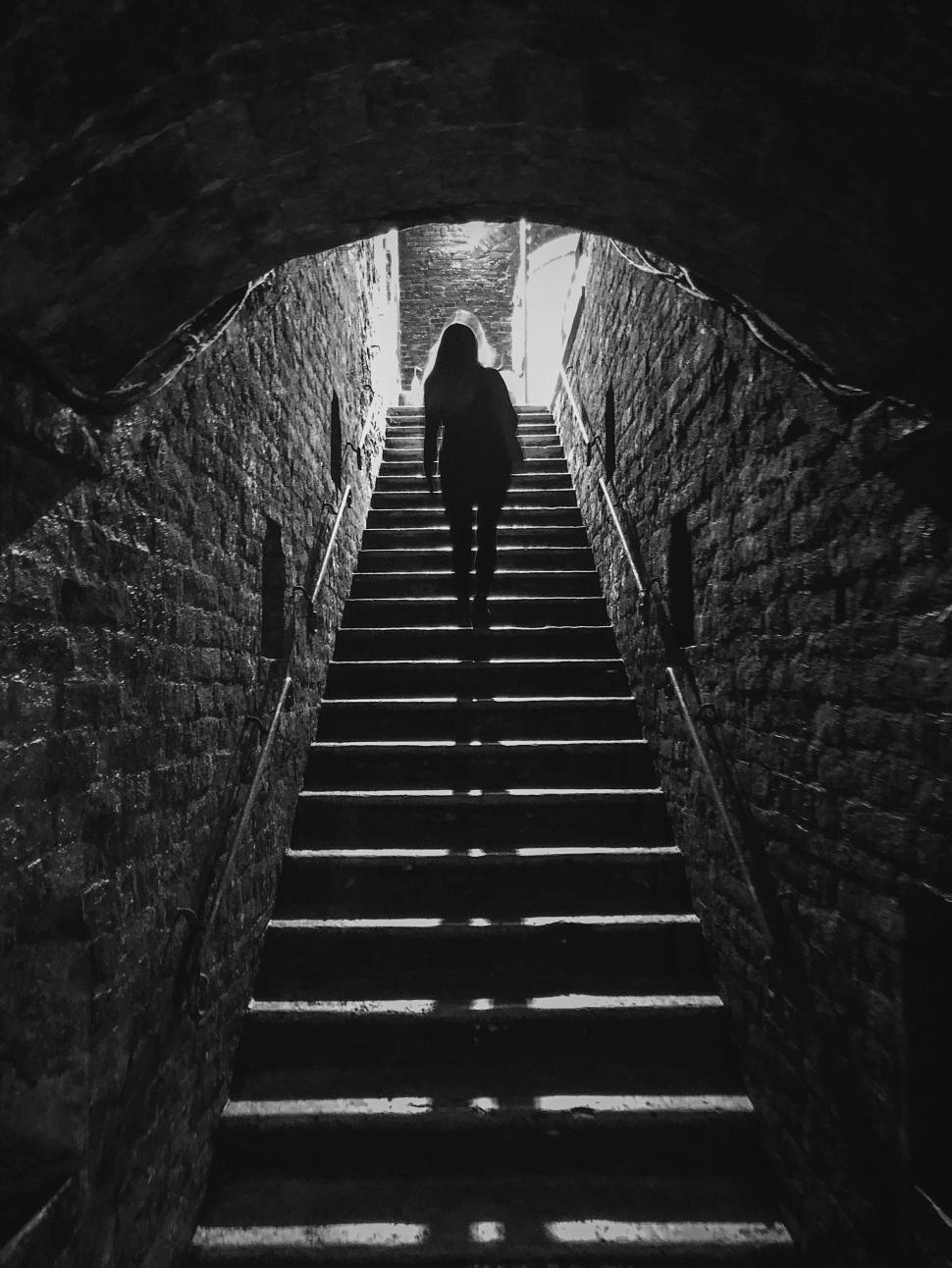 Free Image of Silhouette of a person climbing stairs 