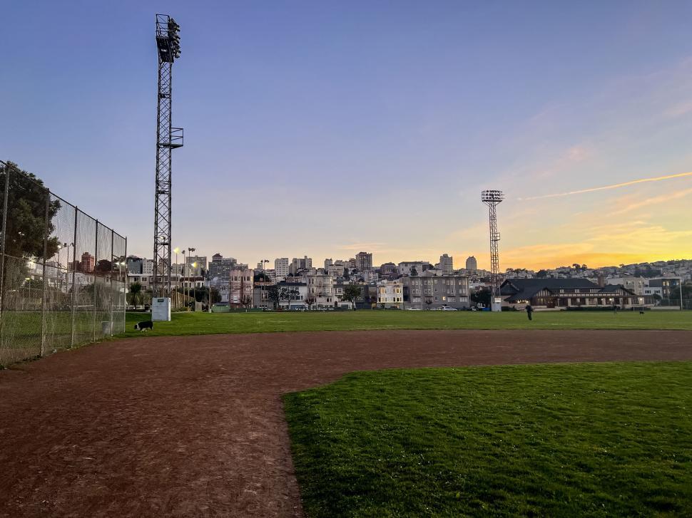 Free Image of Dusk view of a baseball field in the city 