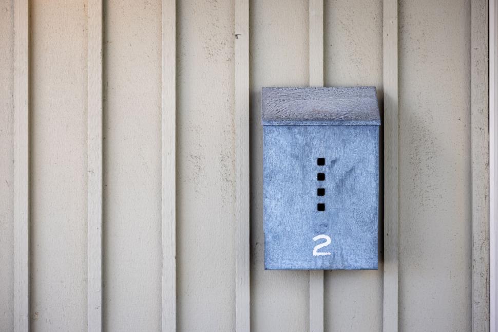 Free Image of Blue mailbox on striped wooden background 