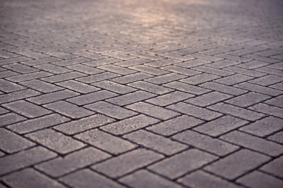 Free Image of Golden hour glow on textured paving stones 