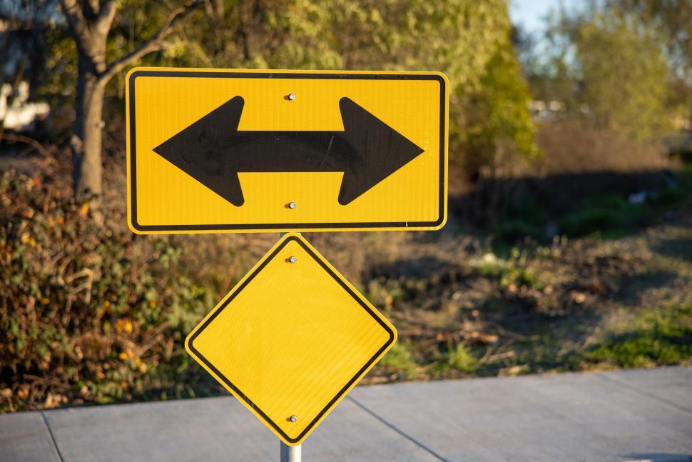 Free Image of Double arrow yellow traffic sign on a street 