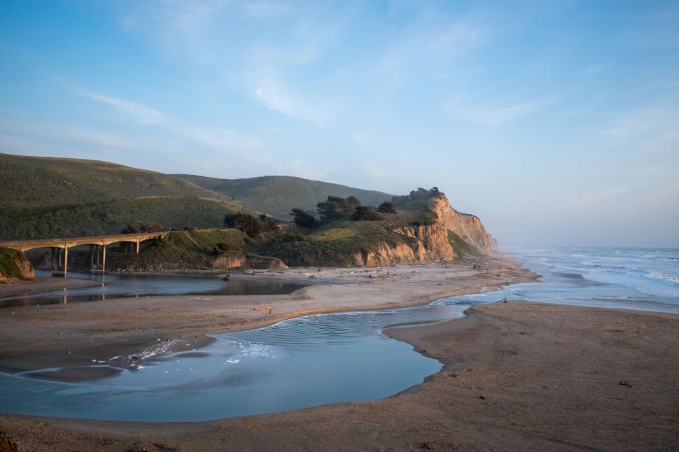 Free Image of Seashore with bridge and cliffs at sunset 