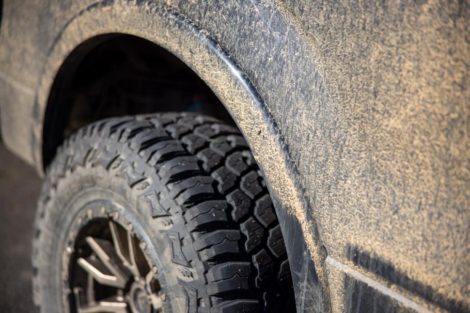 Free Image of Close-up of a muddy off-road vehicle tire detail 