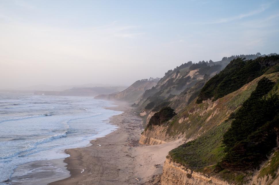 Free Image of Coastal View of Waves Crashing at Sunset 
