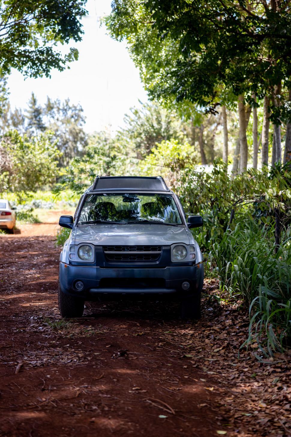 Free Image of Off-road vehicle parked in forest setting 