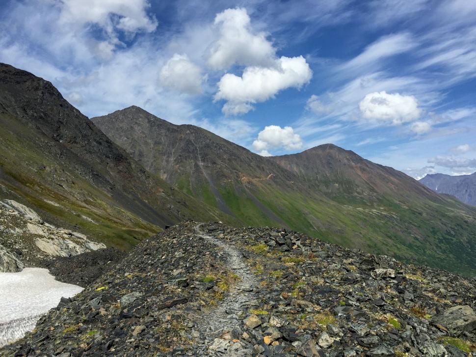 Free Image of Mountainous terrain with cloudy blue sky 