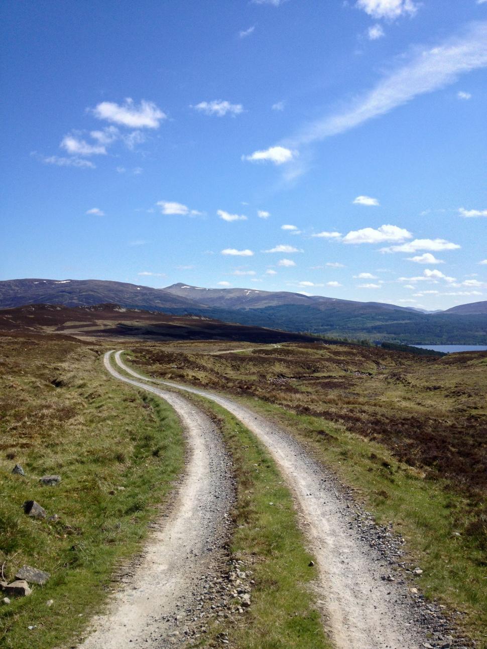 Free Image of A winding dirt road in a scenic landscape 