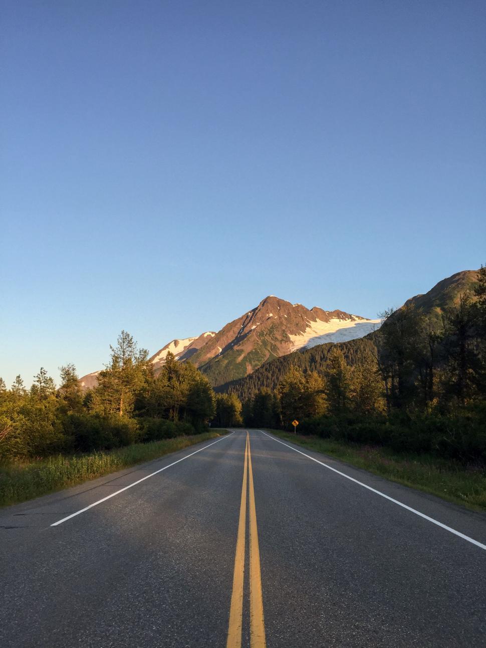 Free Image of Open road through mountain scenery 