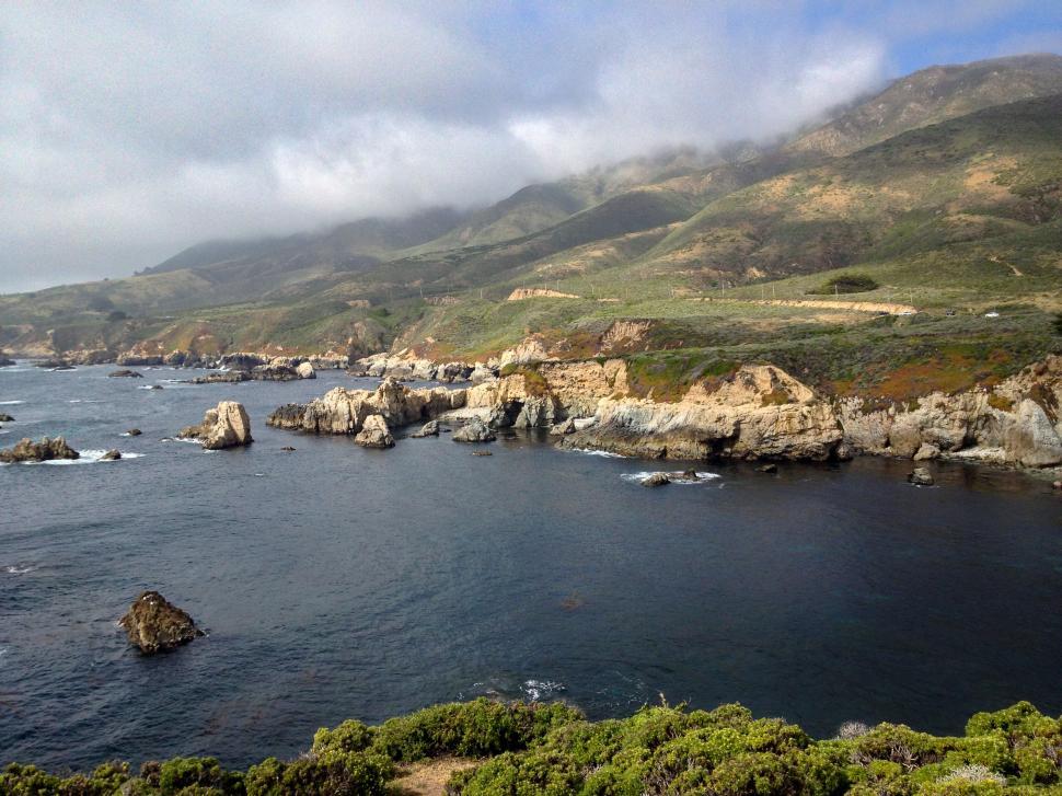 Free Image of Rugged coastal landscape with cloudy sky 