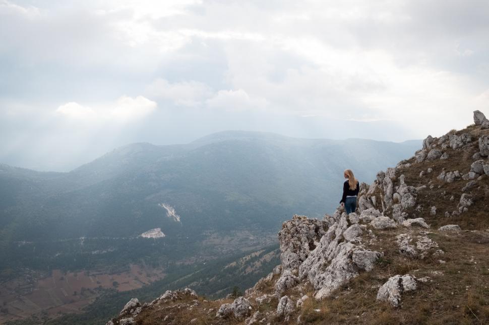 Free Image of Woman contemplating nature on a cliff 