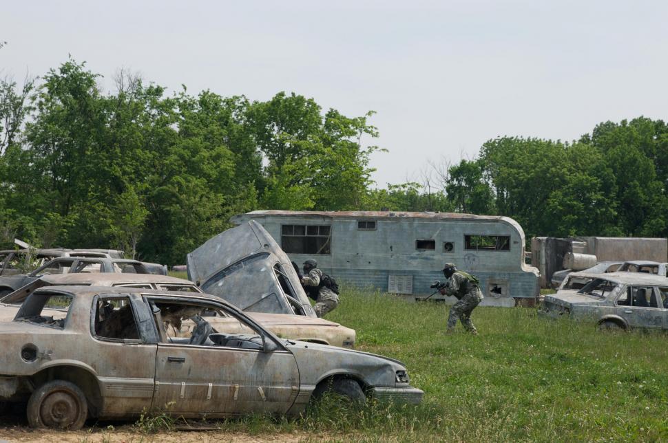 Free Image of Junkyard paintball players in action  