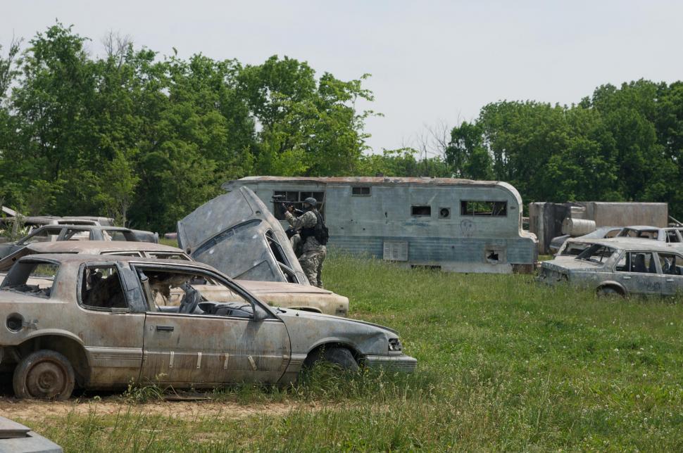 Free Image of Junkyard paintball game in action  