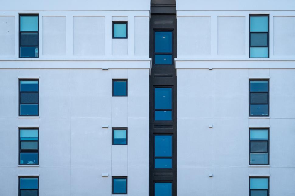 Free Image of Symmetrical pattern of blue windows on a facade 
