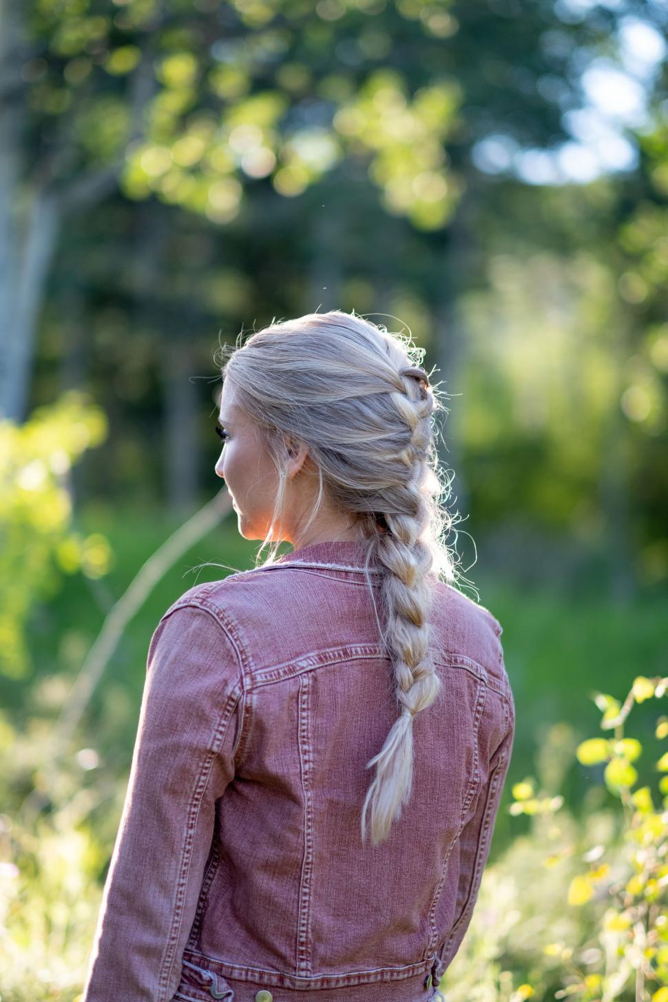 Free Image of Woman in denim with braided hair walking away 