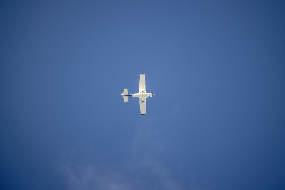 Free Image of Small airplane flying in the blue sky 