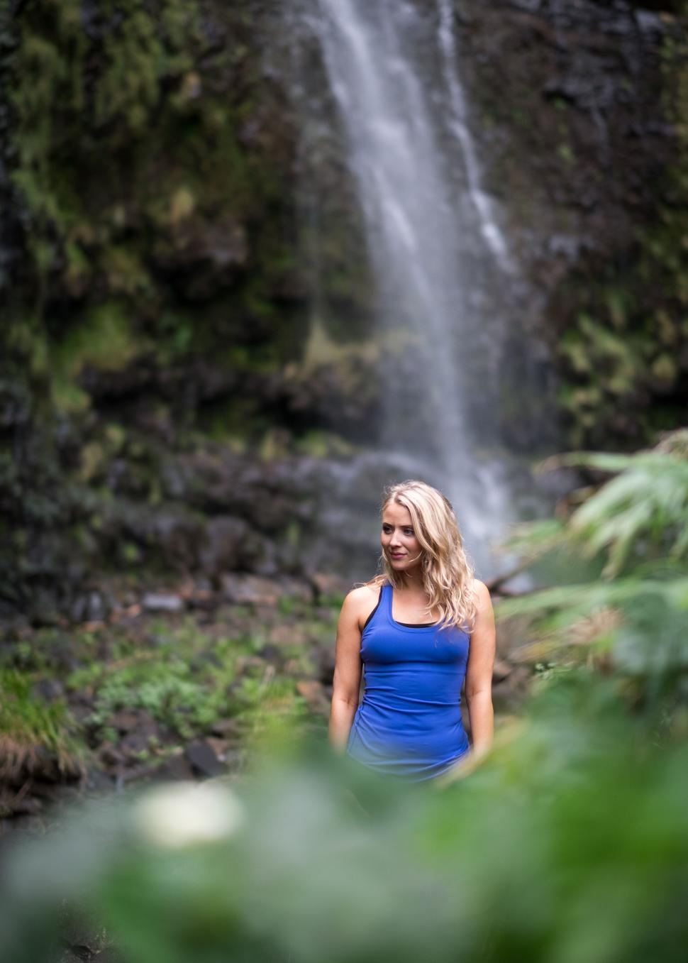 Free Image of Woman in blue near tropical waterfall 