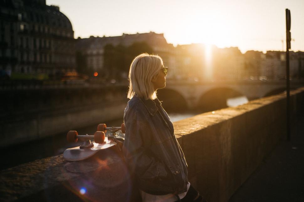 Free Image of Skater girl enjoying sunset by the river 