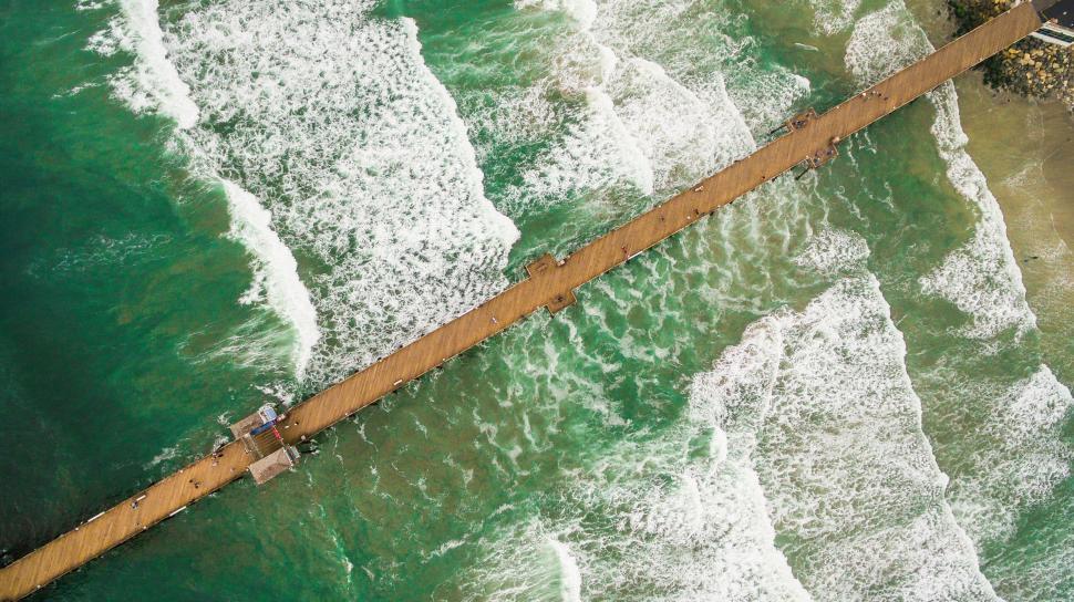 Free Image of Aerial view of a wooden pier in the sea 