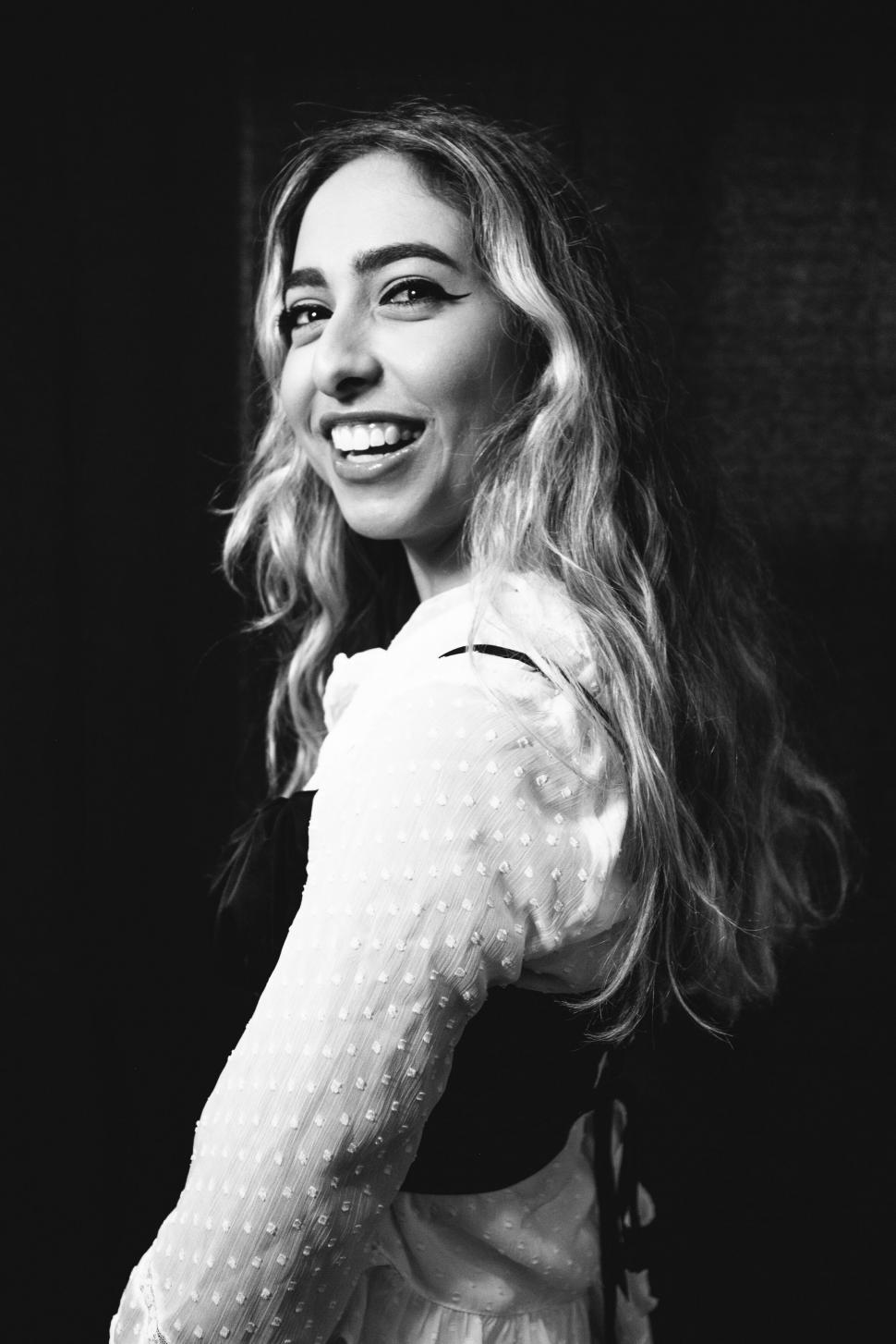 Free Image of Smiling woman in black and white 
