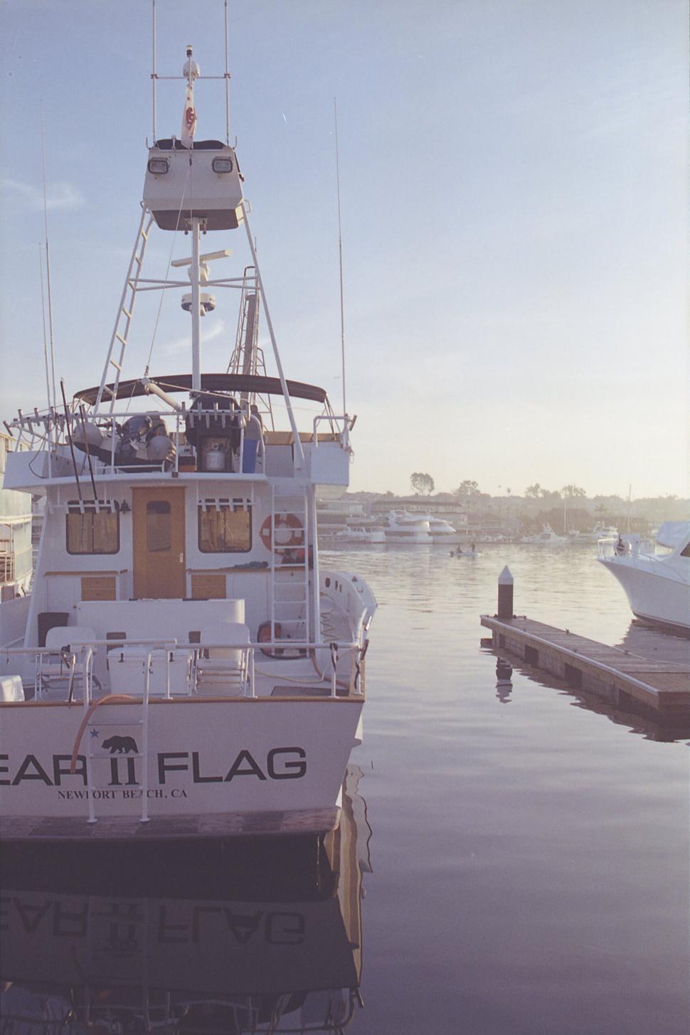 Free Image of Fishing boat moored in calm marina at dusk 