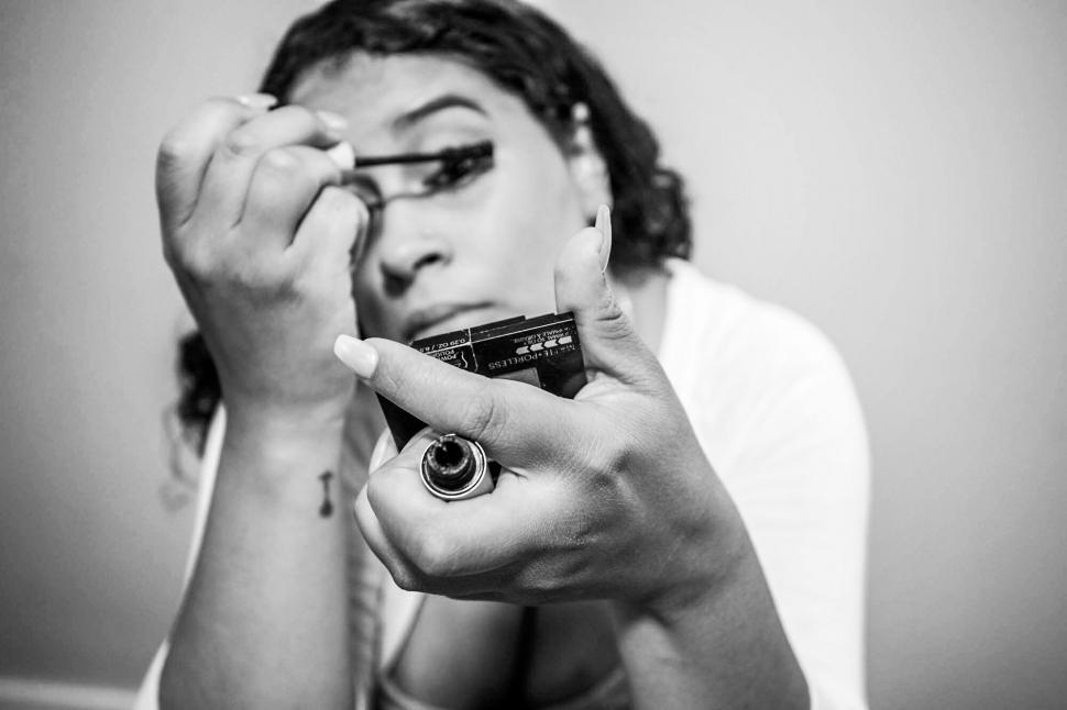 Free Image of Woman pointing gun at camera in monochrome 