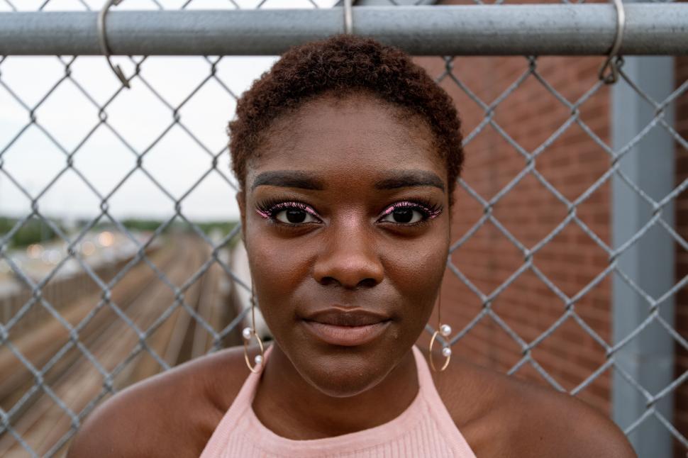 Free Image of Close-up of a woman s face with fence 