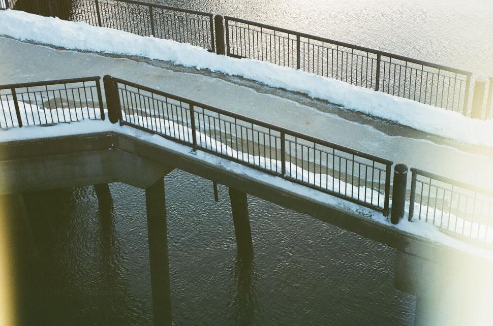 Free Image of Snowy riverwalk with bridge detail 