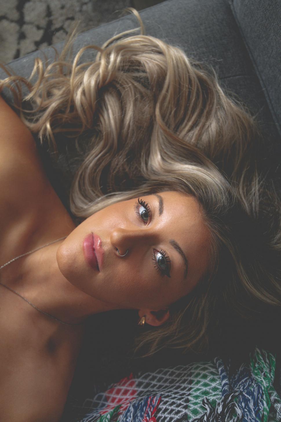 Free Image of Portrait of woman lying on couch 
