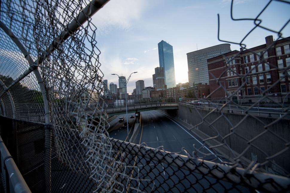 Free Image of City view through a fence at twilight 
