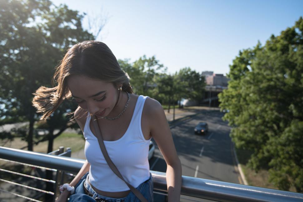 Free Image of Woman on bridge with blurred face 