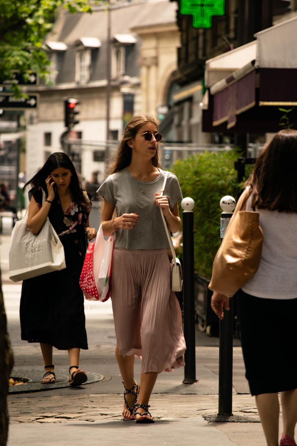 Free Image of Woman walking and talking on the street 