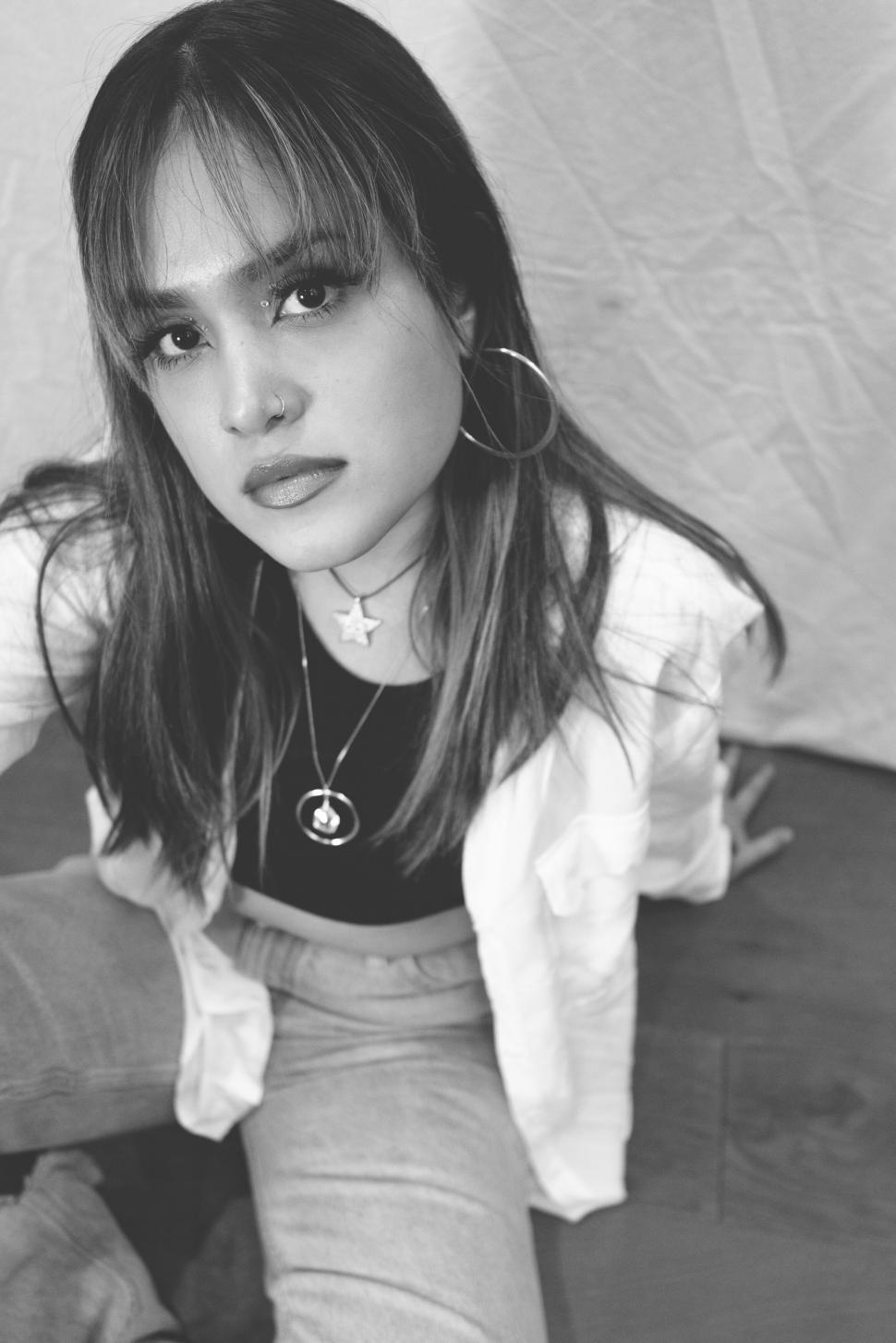 Free Image of Young woman in a B&ampW photoshoot pose 
