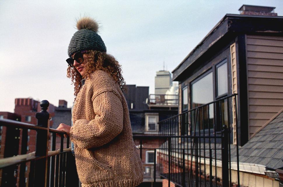 Free Image of Woman on urban balcony at sunset 