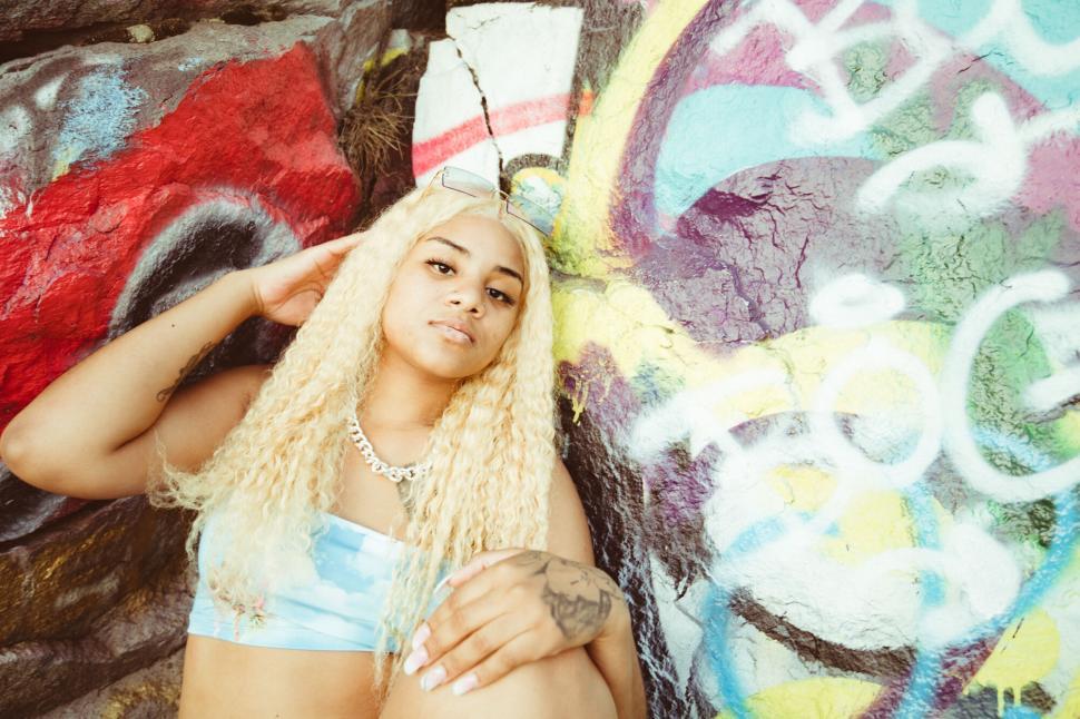 Free Image of Colorful urban graffiti background with young woman 