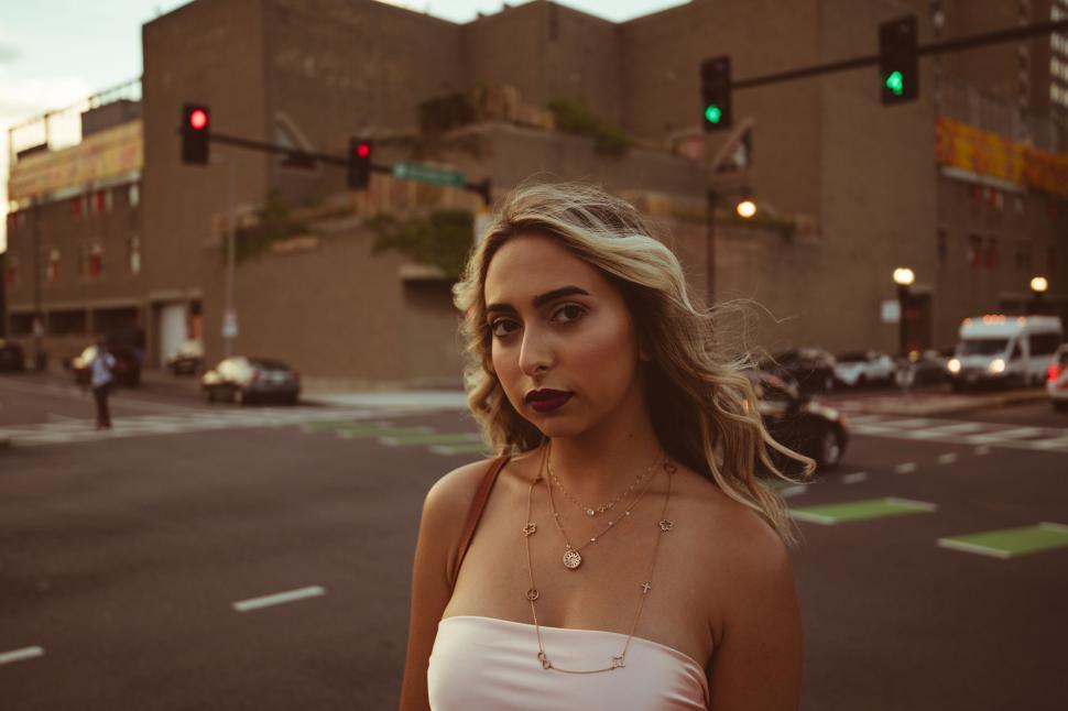 Free Image of Young woman in urban sunset 