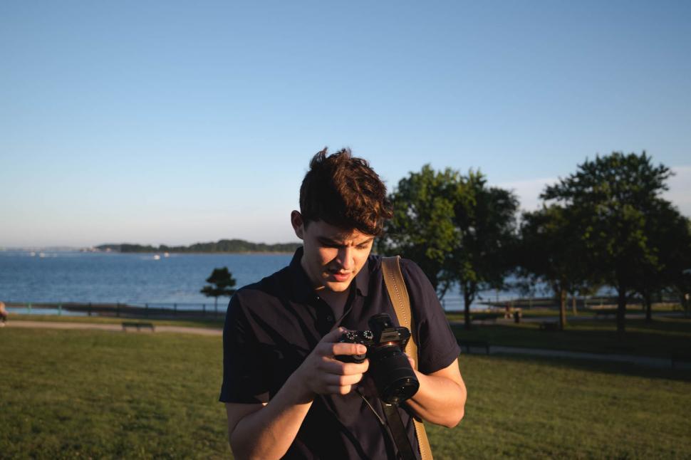 Free Image of Male photographer examining camera 