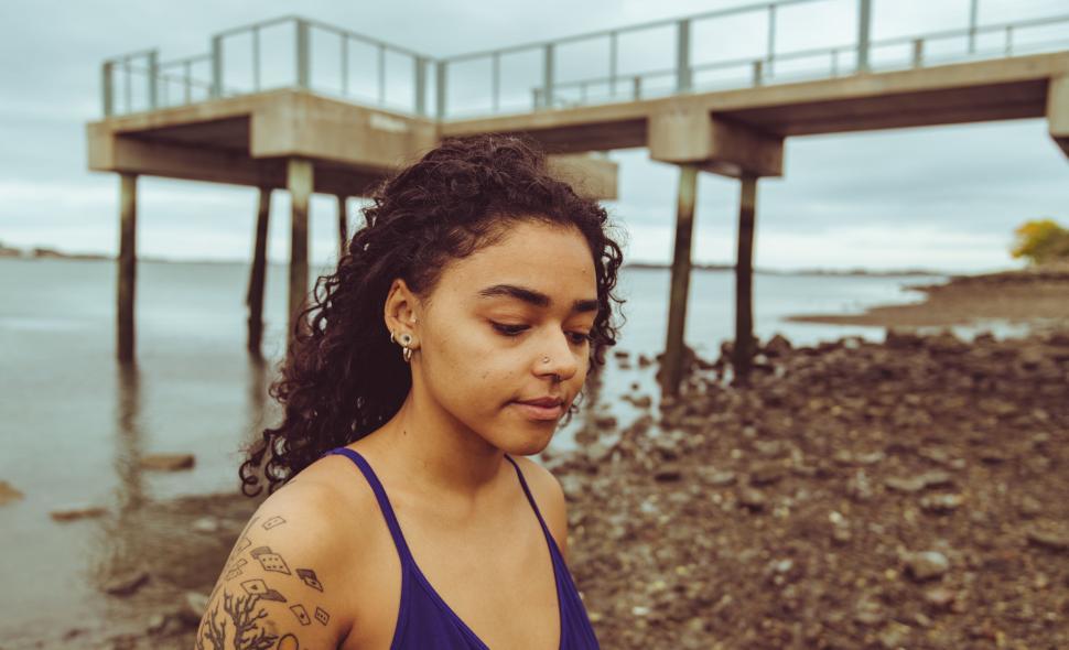 Free Image of Pensive woman near a coastal landscape 