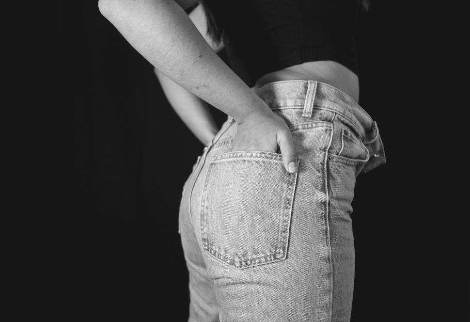 Free Image of Woman in denim attire posing against black backdrop 