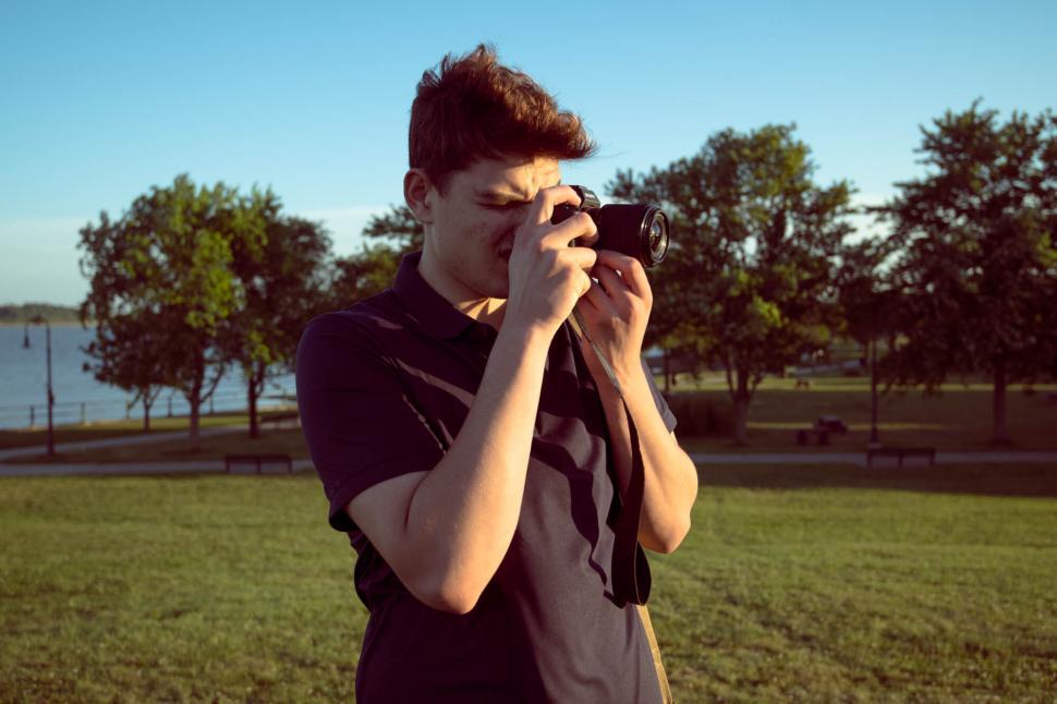 Free Image of Photographer capturing a shot at sunset park 