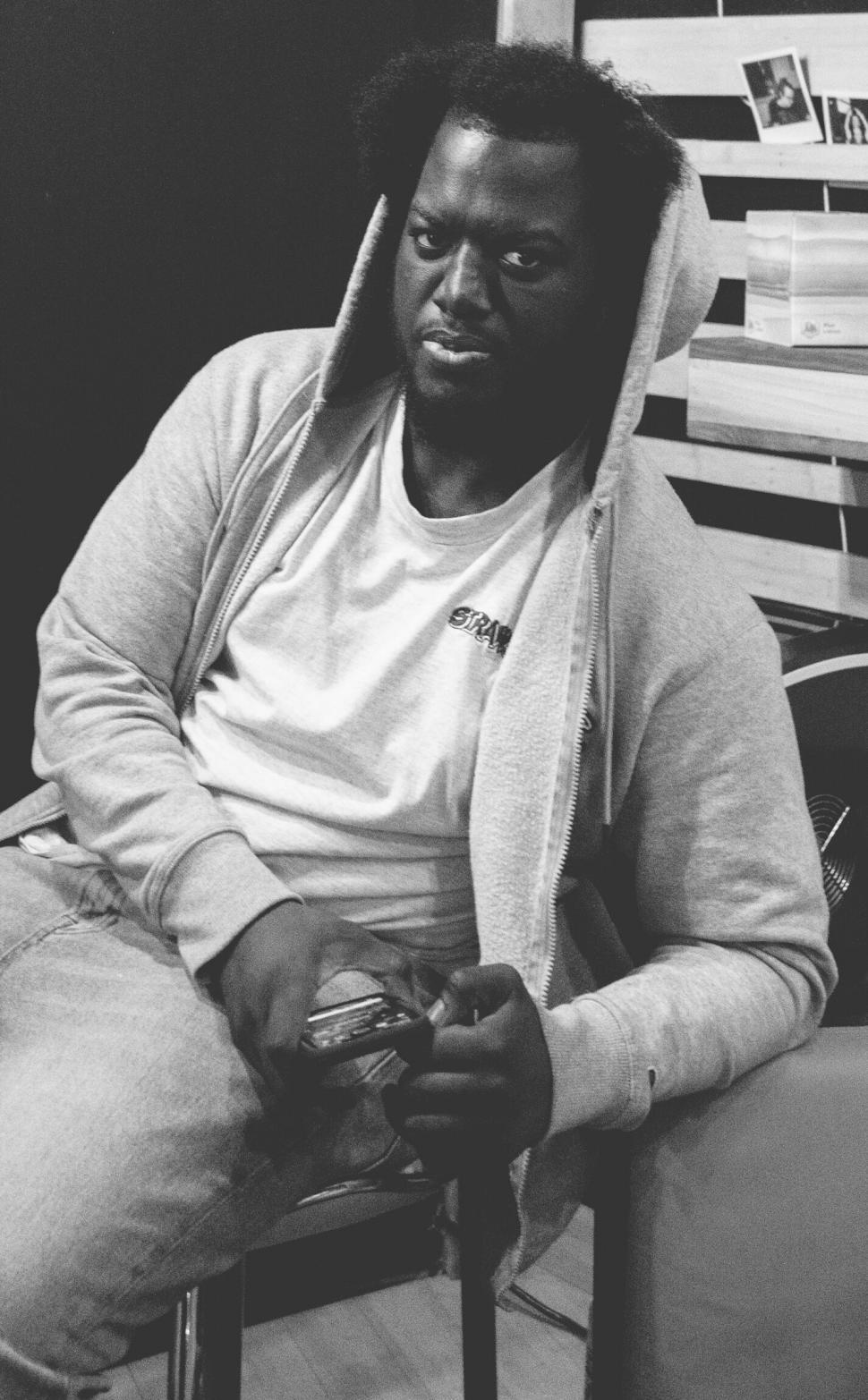 Free Image of Monochrome image of a man sitting casually 